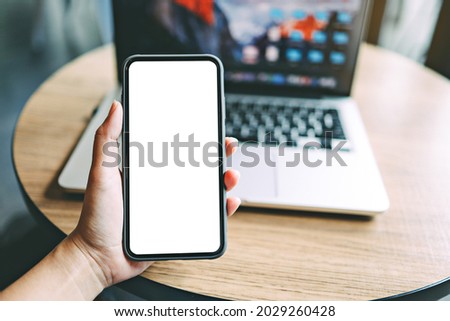 Women's hands holding cell telephone blank copy space screen. smartphone with blank white screen isolated. smart phone with technology concept
