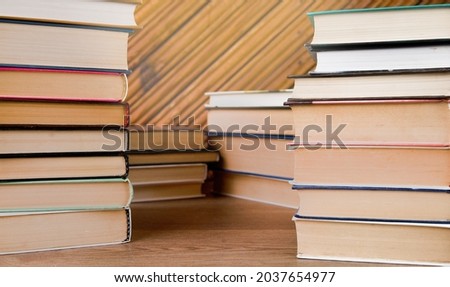 Stacks of books on a wooden background.