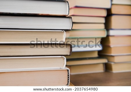 a stack of books on a wooden background