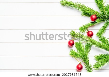 New Year's composition. Fresh fir branches with red baubles. Place for your text