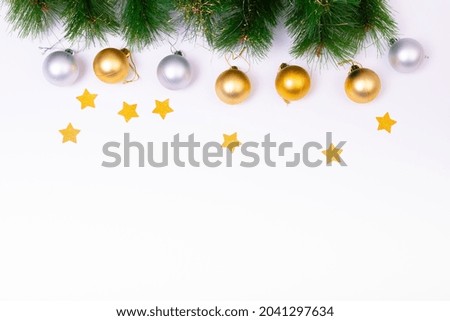 Composition of fir tree branches with baubles, stars and copy space on white background. christmas, tradition and celebration concept.