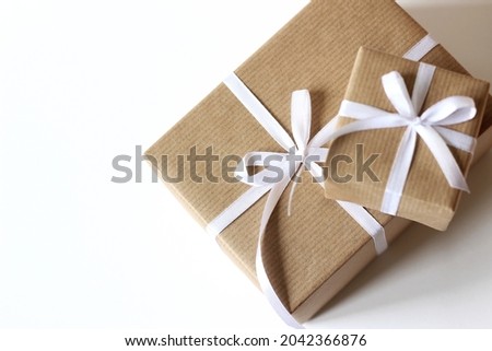 Christmas Gift Boxes Closeup. Wrapped Holidays Gifts Decorated with White Ribbon Bows. Holidays Celebration Concept.