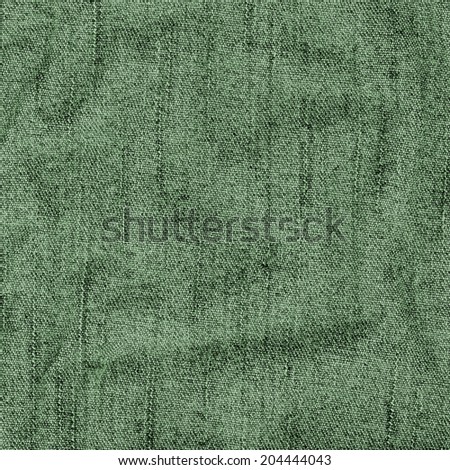 green background of crumpled jeans fabric 