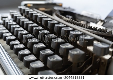 Old Thai traditional typewriter. Classic vintage antique manual typing machine isolated on white background. 19th century item.