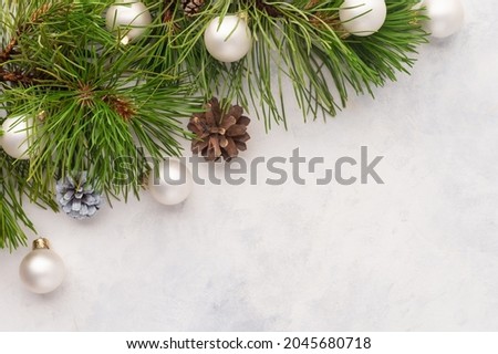 Pine branches, Christmas balls and pine cones on a white background. Stylish frame for your inscription. Christmas, New Year, congratulation, postcard, banner, poster.