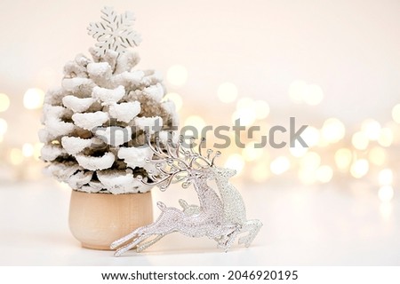 Christmas composition.Christmas, winter, new year concept. Deer, Christmas tree and lights on the background