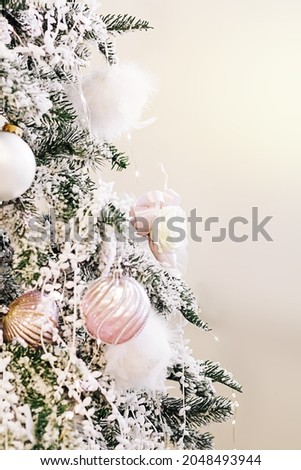 Christmas tree decorated with beautiful shiny  pink baubles and white decorations. Copy space