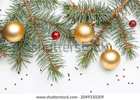 Fir tree branch with beautiful Christmas balls on white background