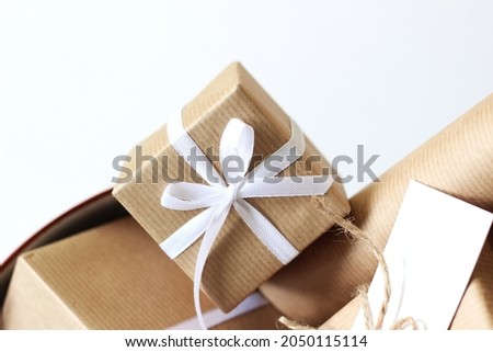 Holiday Gift Boxes Closeup. Wrapped in Brown Kraft Paper Presents for Christmas Season.