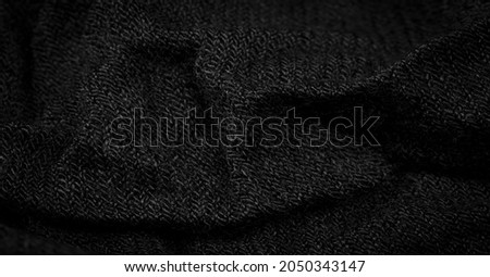 Black rough woolen fabric. Sheep with long, durable, coarse-fiber wool, especially suited to your design. As with various large breeds of lamb of English origin. Texture background pattern