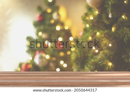 Wood table top on blur Christmas tree background. For display or montage your products.