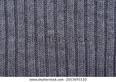 Closeup texture of gray knitted sweater.