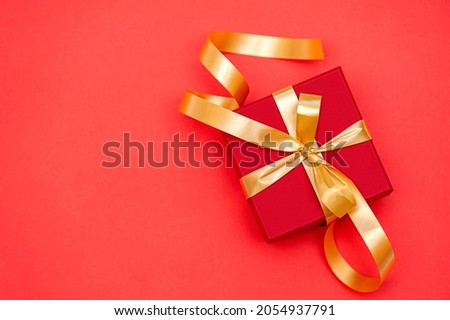 Red gift box on red background