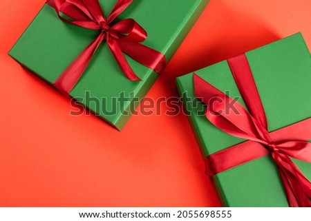 top view of green wrapped presents on red background