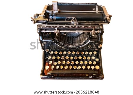 An old vintage Typewriter with spanish keyboard over a wooden desk, isolated on white background