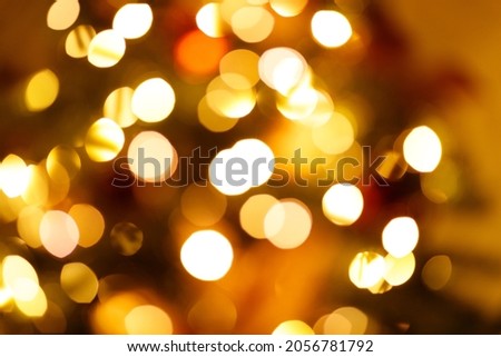 Warm golden festive new year garland lights blurred background.