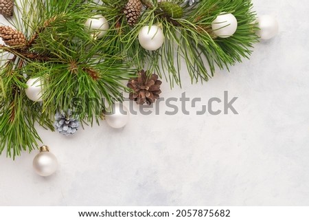 Stylish Christmas and New Year frame for your lettering made of pine branches, Christmas balls and cones. White background. Minimalism. Christmas. New Year, postcard, greeting.