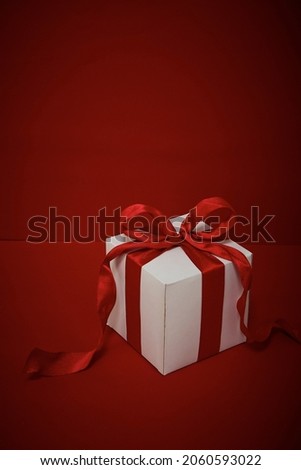 Gift box Christmas with red ribbon on red background