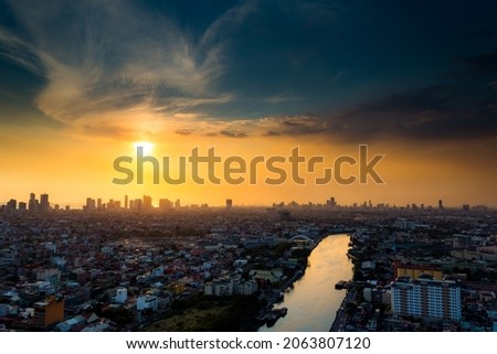 Sunset by the city where the horizon is changing from yellow afternoon to dark night