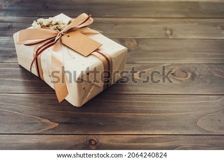 Craft gift box on table wooden background with copy space