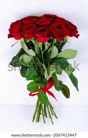 Bouquet of beautiful roses tied with red ribbon. Studio Photo