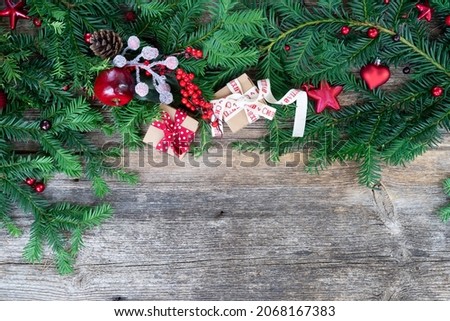 Christmas gift giving and zero waste concept - wrapped christmas gift box, border on wooden background
