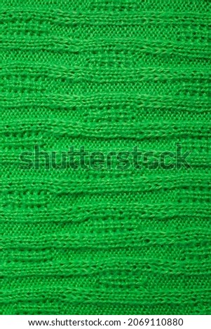 knitted pattern on a green woolen plaid