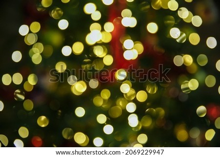 Blurred background of Christmas tree, in lights and decorations