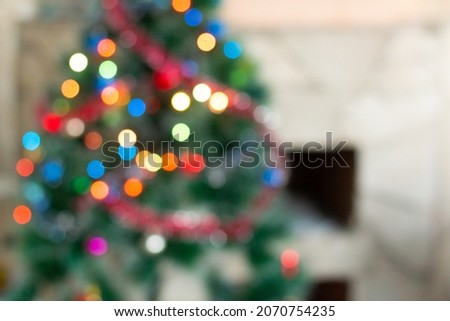 Decorated Christmas tree and fireplace. The photo is out of focus. Christmas background. No focus.