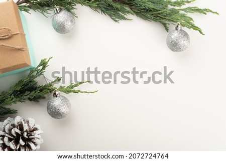 Flat lay with Christmas tree branches, pine cones, Christmas baubles, presents. Copy space. 