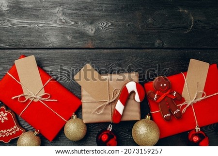 Christmas present and festive gingerbread cookies on wooden background