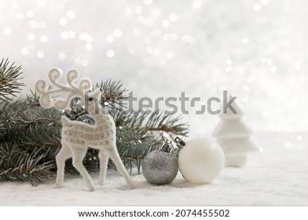 Christmas card with a deer and Christmas decorations. Copy space.