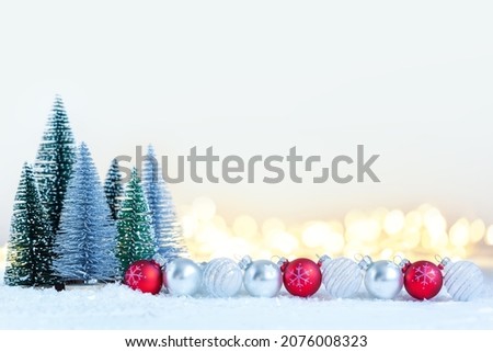 Christmas composition trees with many bauble on festive light background with defocused boke. Holiday concept.
