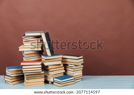 stacks of educational books in the library on a brown background