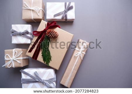 Christmas background with gift boxes and ornaments in light green color. Xmas celebration, greetings, preparation for winter holidays. Festive mockup, top view, flat lay with copy space.