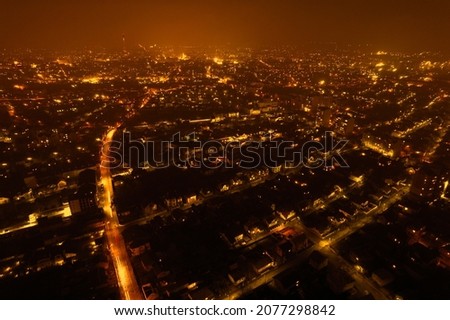 Amazing panoramic view of the evening city from above. Aerial view, night view of the city with night sky. Beautiful street lighting in the lanterns