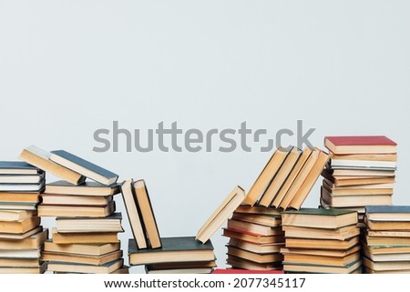 stacks of educational books in the college library on a white background
