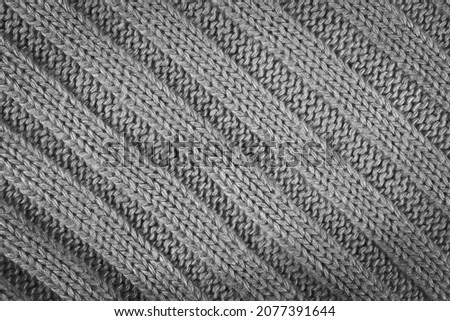 grey knitted textured background with a pattern closeup