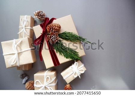  Christmas background with gift boxes and ornaments in gray color. Xmas celebration, greetings, preparation for winter holidays. Festive mockup, top view, flat lay with copy space.
