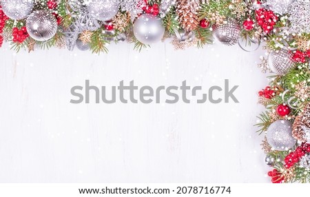 Christmas Card with Fir Branches, Silver Balls and Snowfall on White Holiday Background. Christmas Decoration