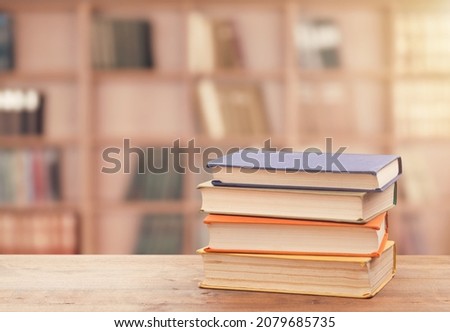 Stack of books on the table in the library background