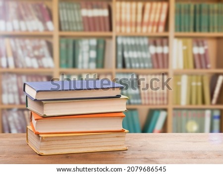 Stack of books on the table in the library background