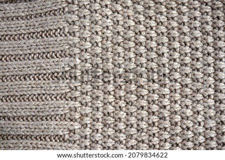 knitted background from a scarf knitted with a pattern of buckwheat and elastic