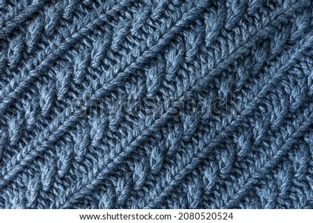 gray woven fabric texture background. sample of grey wool knitting. Figured knitting for a product. Textured wool warm knitted fabric. Texture for designers. diagonal arrangement