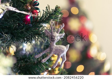 Decorated Christmas tree and colorful presents on colorful bokeh background. Merry Christmas and Happy Holidays. Christmas holiday celebration. Happy new year concept.