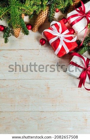 Christmas classic background with Christmas tree branches, decorations and gift boxes, flatlay top view copy space 