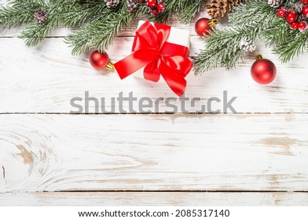 Winter fir tree with snow and decorations at white table.