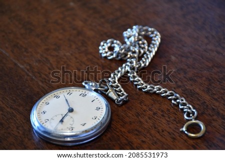 An old pocket watch on the table.