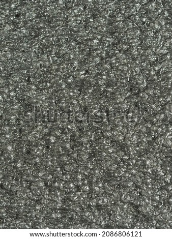 close up, background, texture, large vertical banner. surface structure black expanded polyethylene, EPE, padding cushioning material for packages. full depth of field. high resolution photo