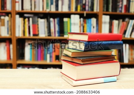 Stack of books on table in library